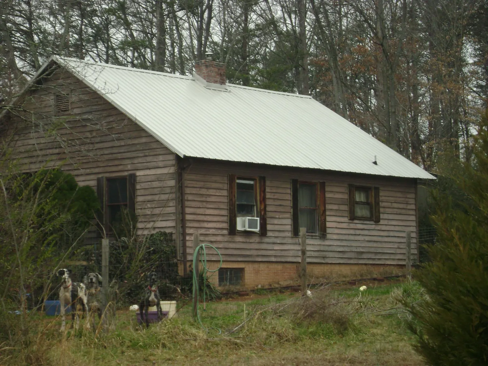White metal roof on an old wood sided farmhouse, from a Metal Roof Installation job in Reading